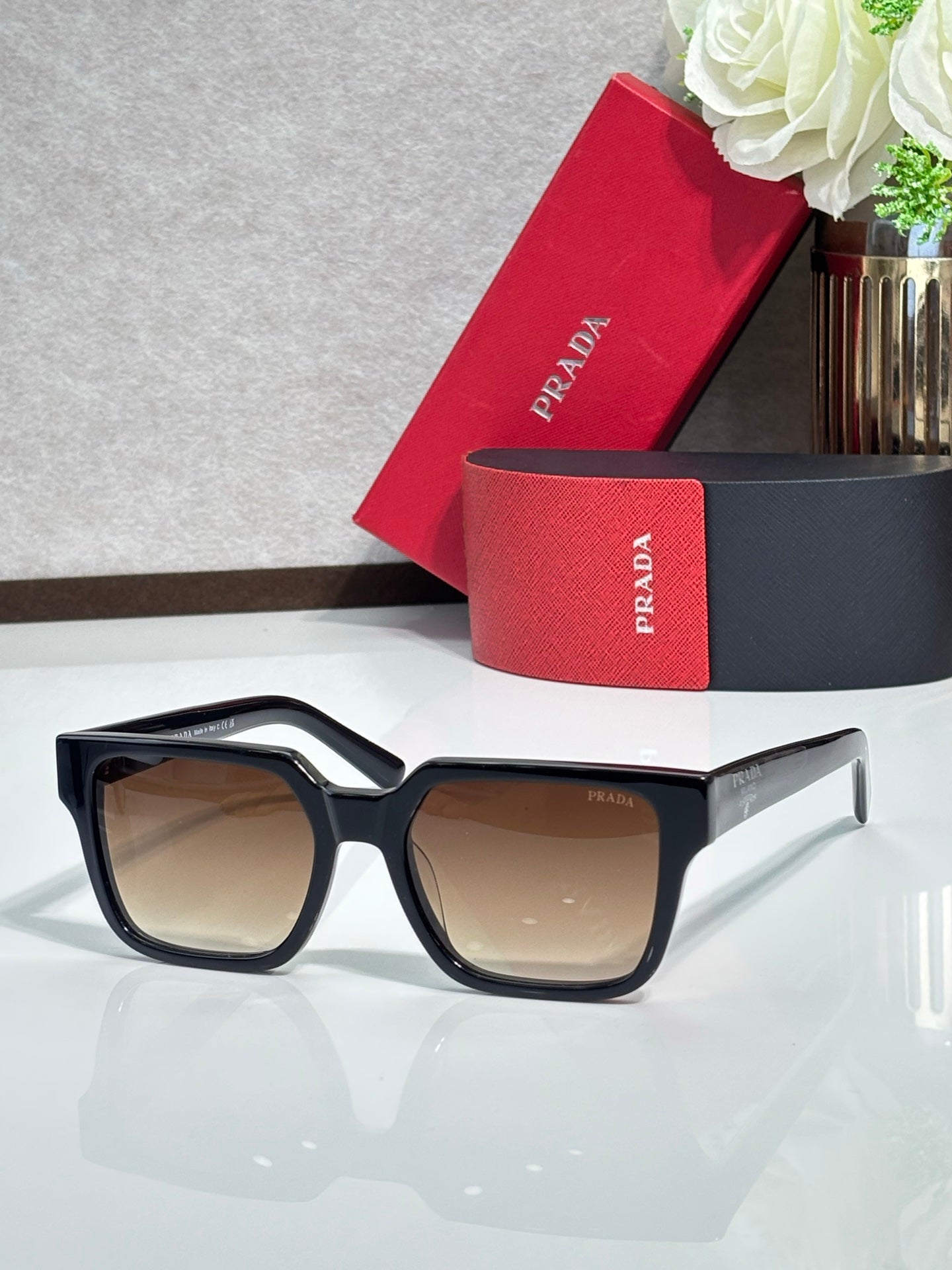 Prada sunglasses with black frame and tan-tinted lenses