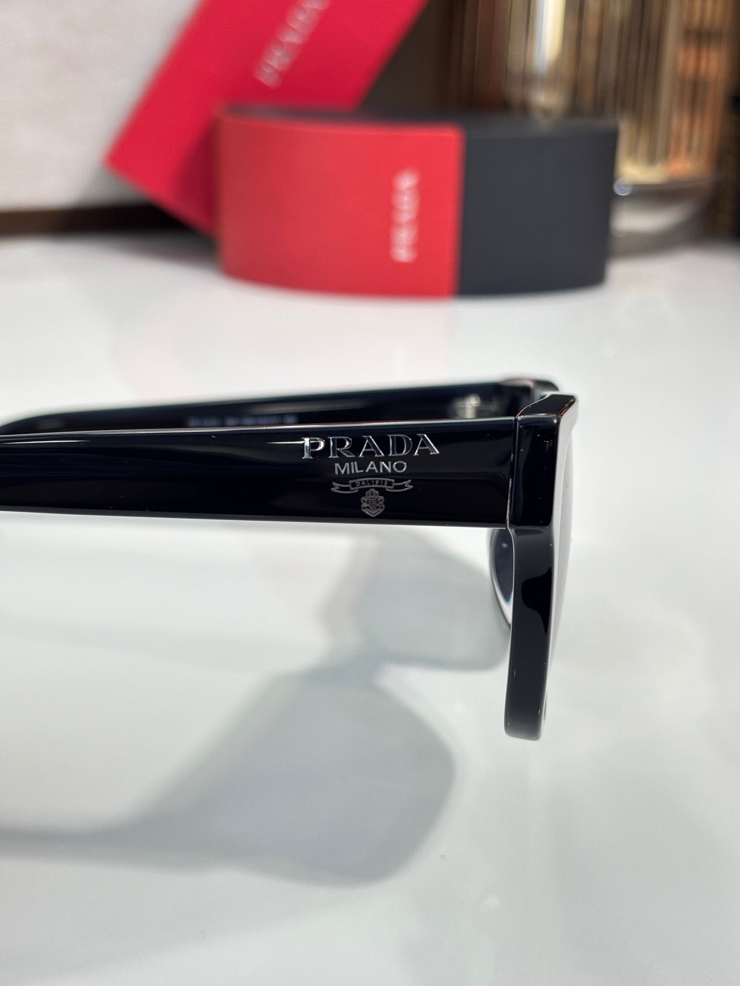 Prada sunglasses temple close-up with Prada Milano engraving