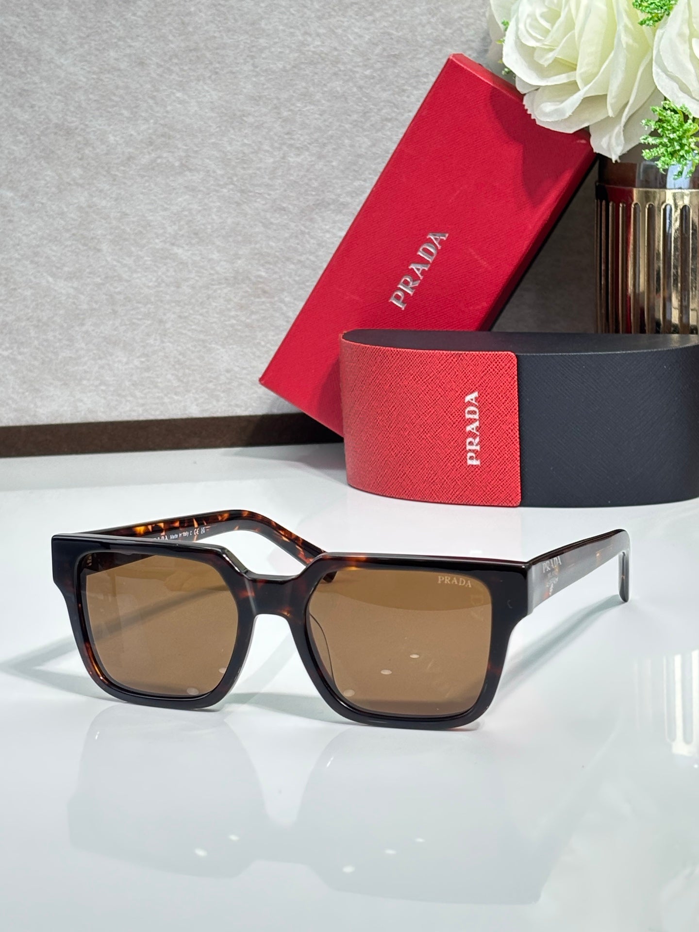 Prada sunglasses with tortoiseshell frame and amber-tinted lenses
