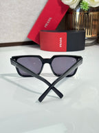 Prada sunglasses with black cat-eye frame and dark tinted lenses