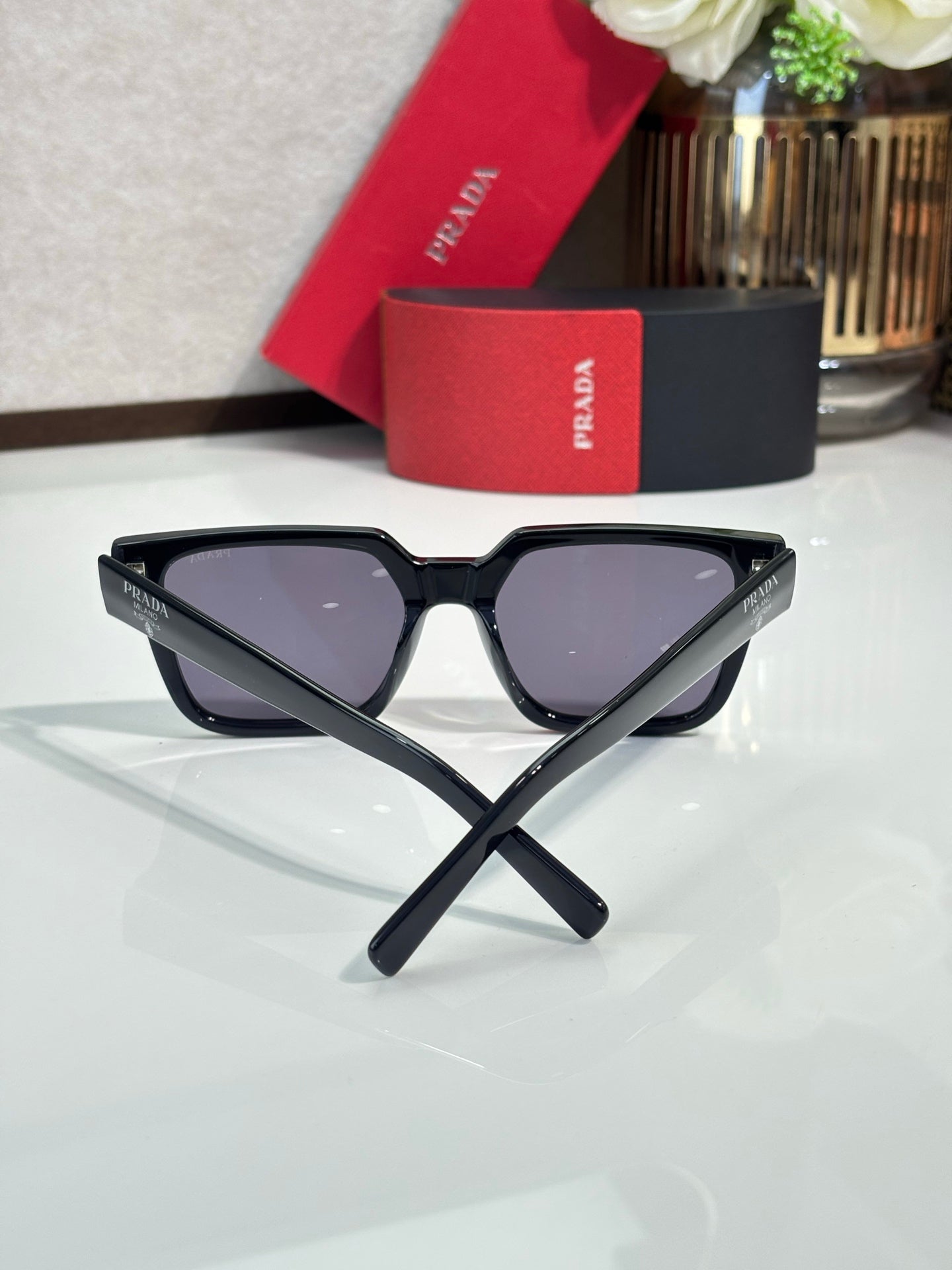 Prada sunglasses with black cat-eye frame and dark tinted lenses