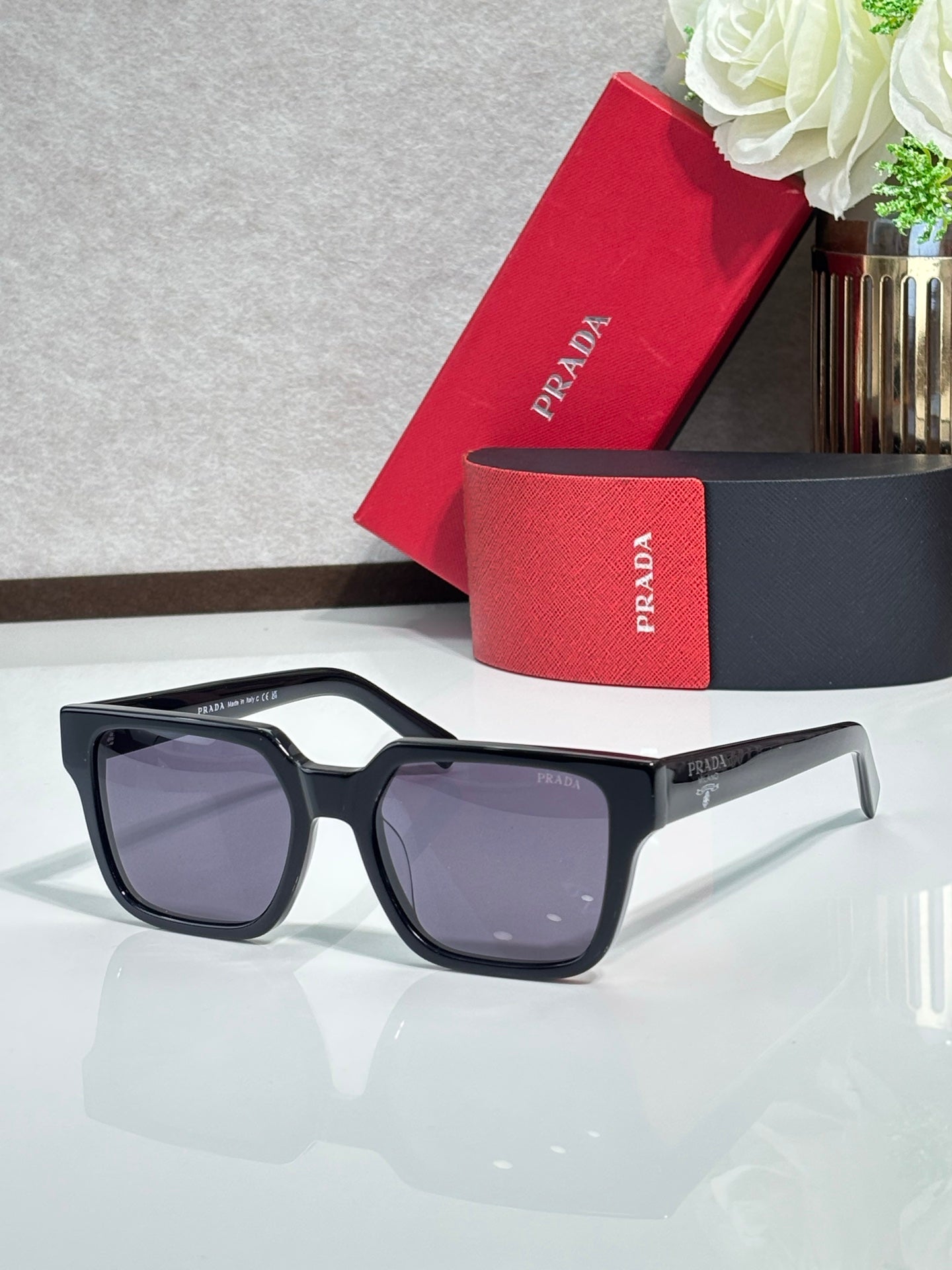 Prada sunglasses with black frame and dark tinted lenses