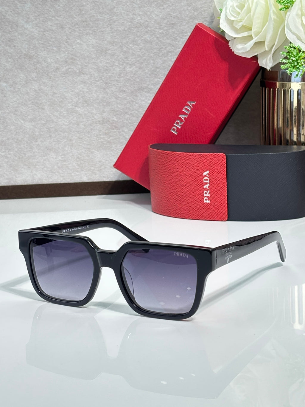Prada sunglasses with black cat-eye frame and dark tinted lenses