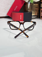 Tortoise rectangular eyeglasses with clear lenses and logo on temple, angled