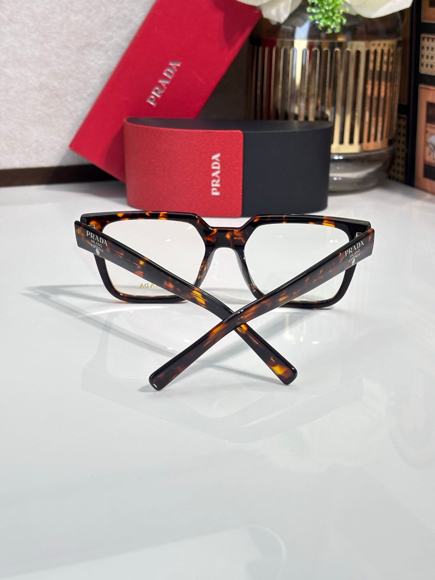 Tortoise rectangular eyeglasses with clear lenses and logo on temple, angled