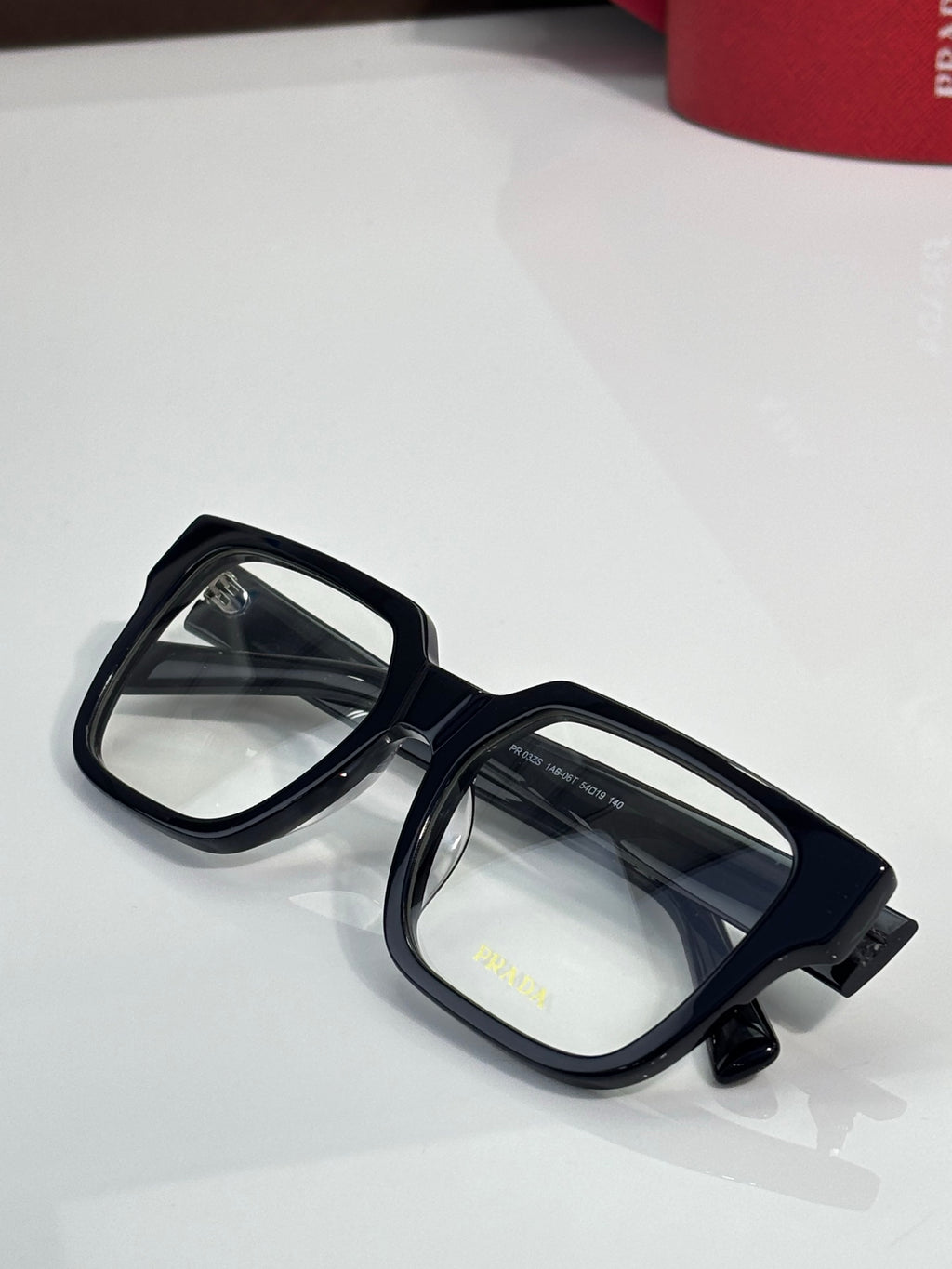 Black rectangular eyeglasses with clear lenses and glossy temple details