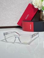 Silver rectangular eyeglasses with clear lenses and logo on temple