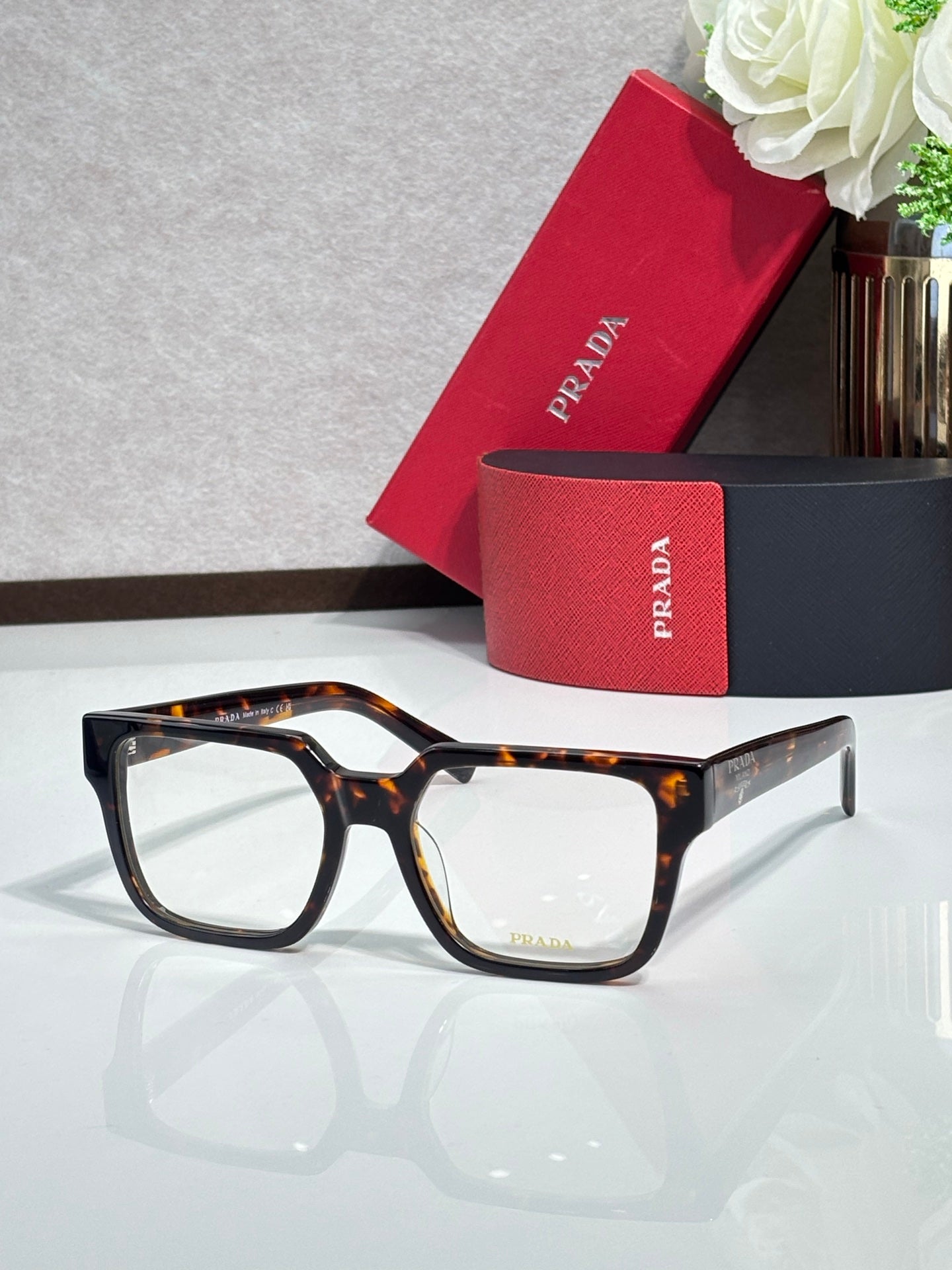 Tortoise-pattern rectangular eyeglasses with clear lenses and temple logo