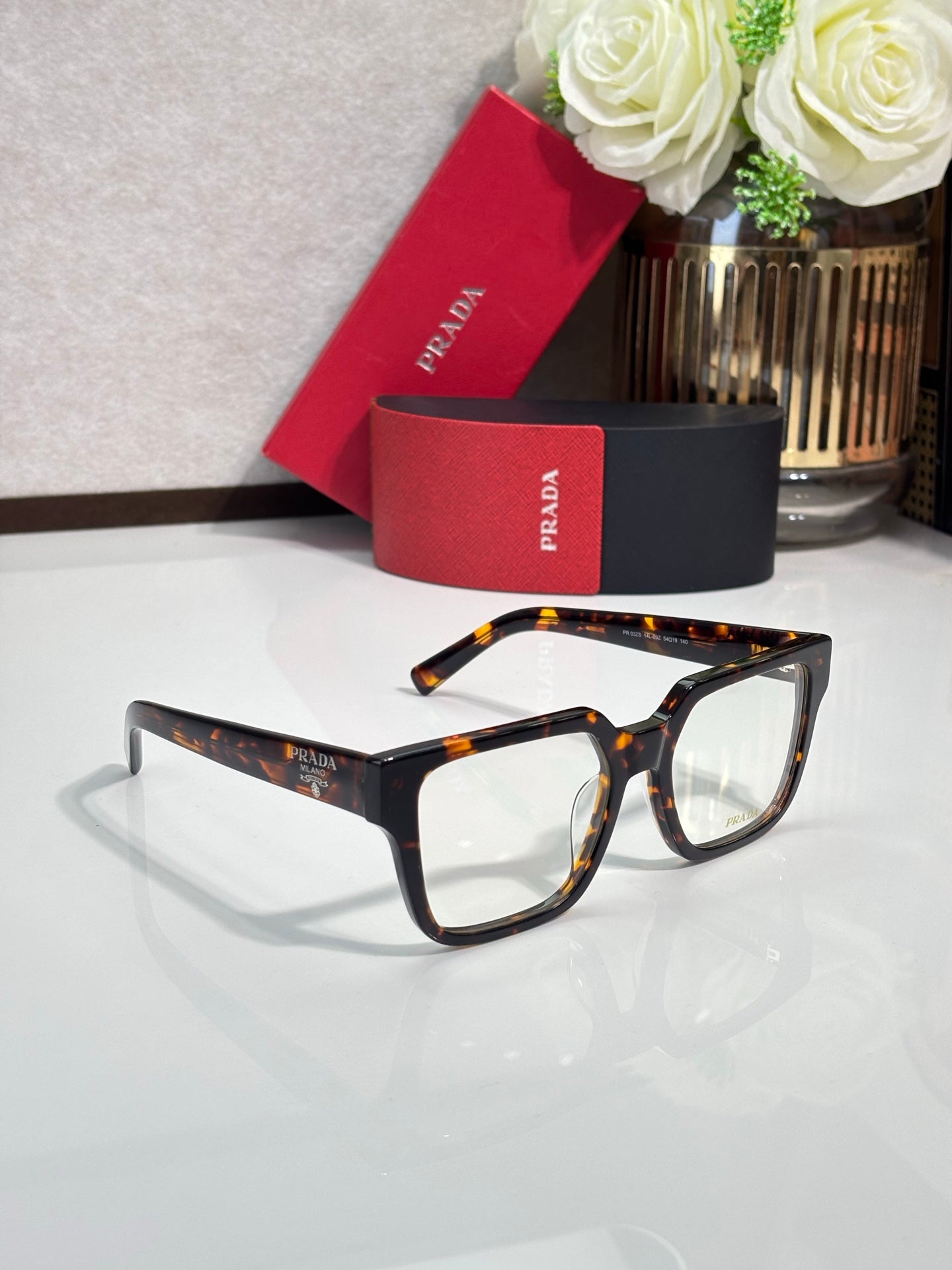 Tortoise and black rectangular eyeglasses with clear lenses