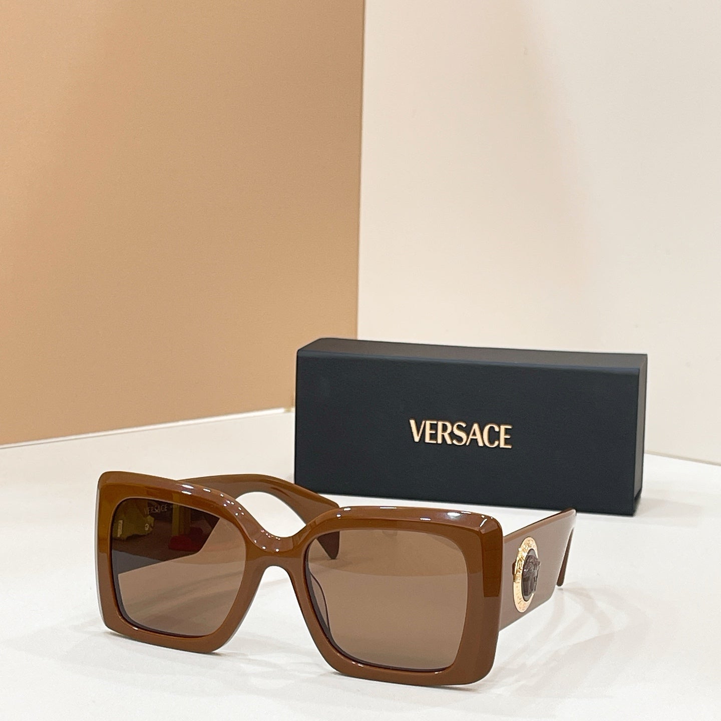Versace glasses, brown square frames with gold logo and warm-tinted lenses
