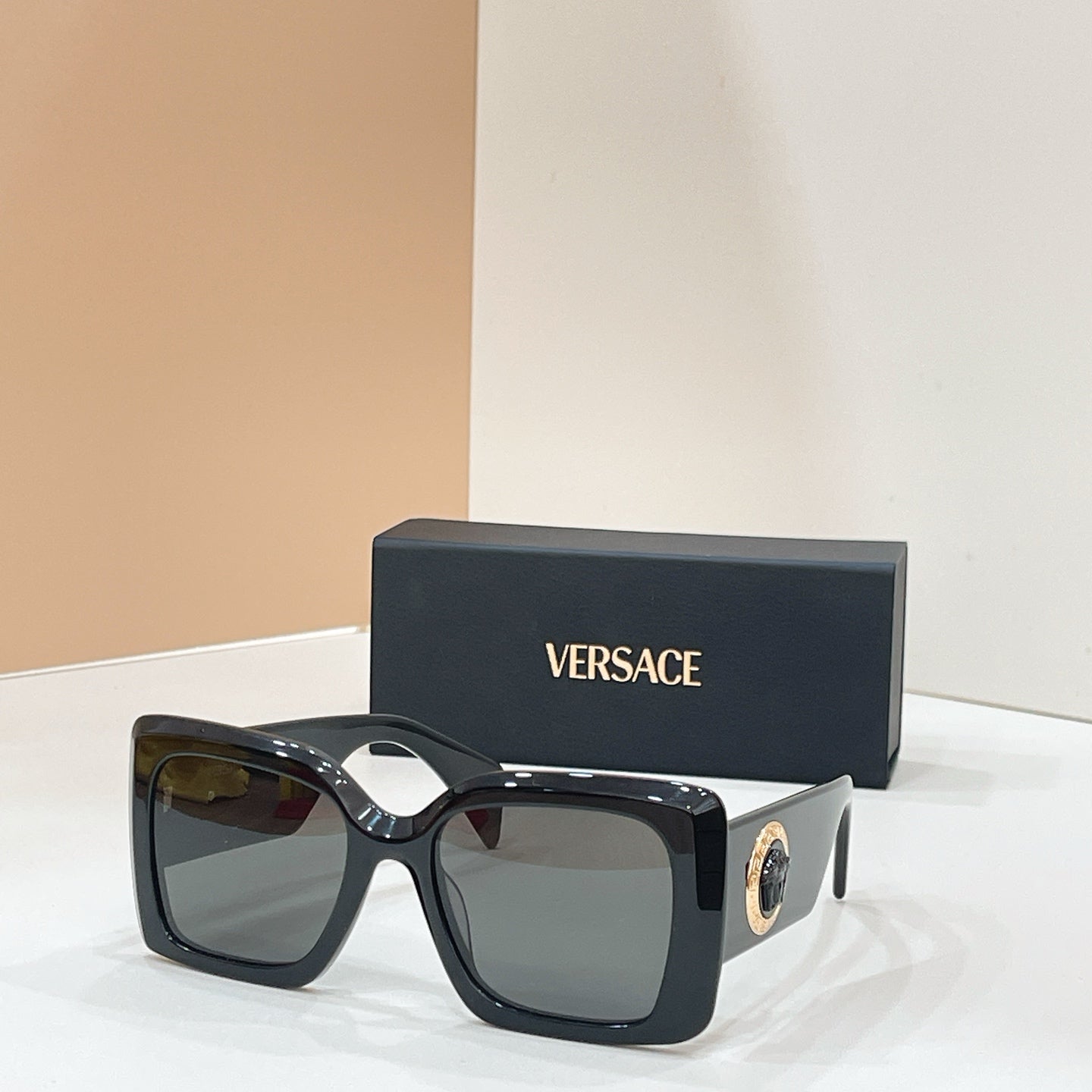 Versace glasses, black square frames with gold logo and dark tinted lenses