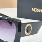 Versace glasses, close-up of dark frame with gold emblem on temple hinge