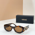 Tortoiseshell sunglasses with brown-tinted lenses and gold logo medallion on the temple