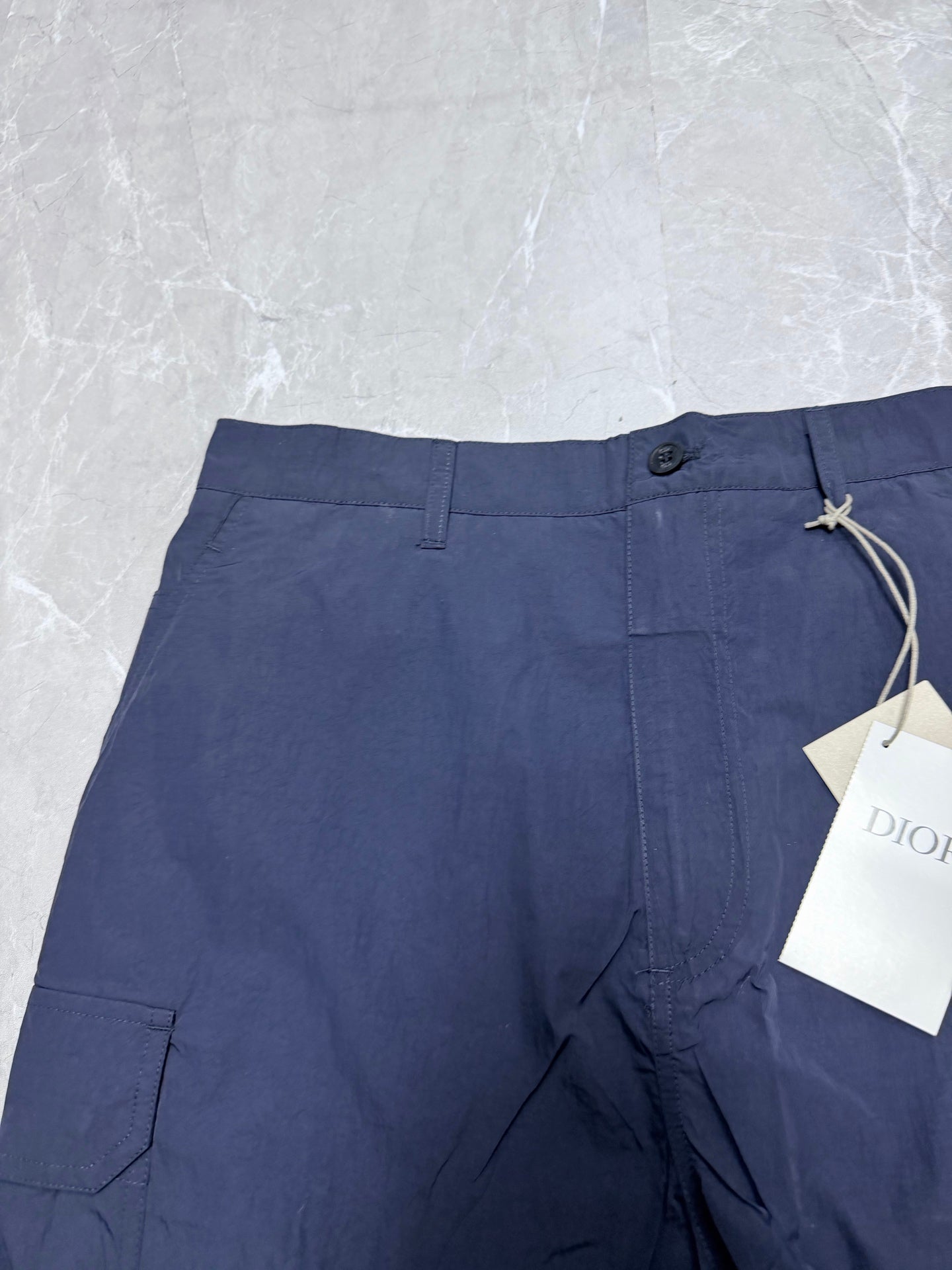 Navy Dior shorts with button fly and drawstring tie at waistband