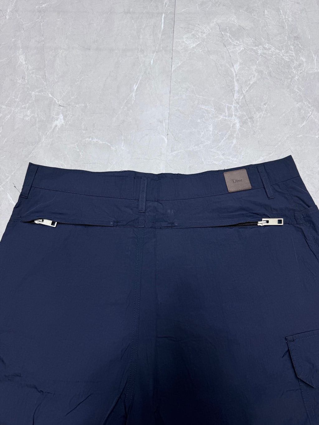 Navy Dior shorts back view with belt loops and small logo label