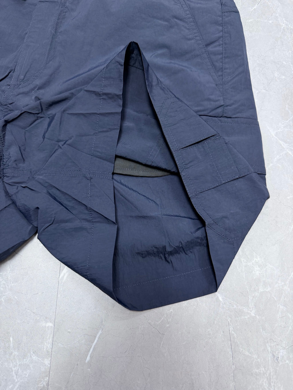 Navy Dior shorts interior seam and curved hem