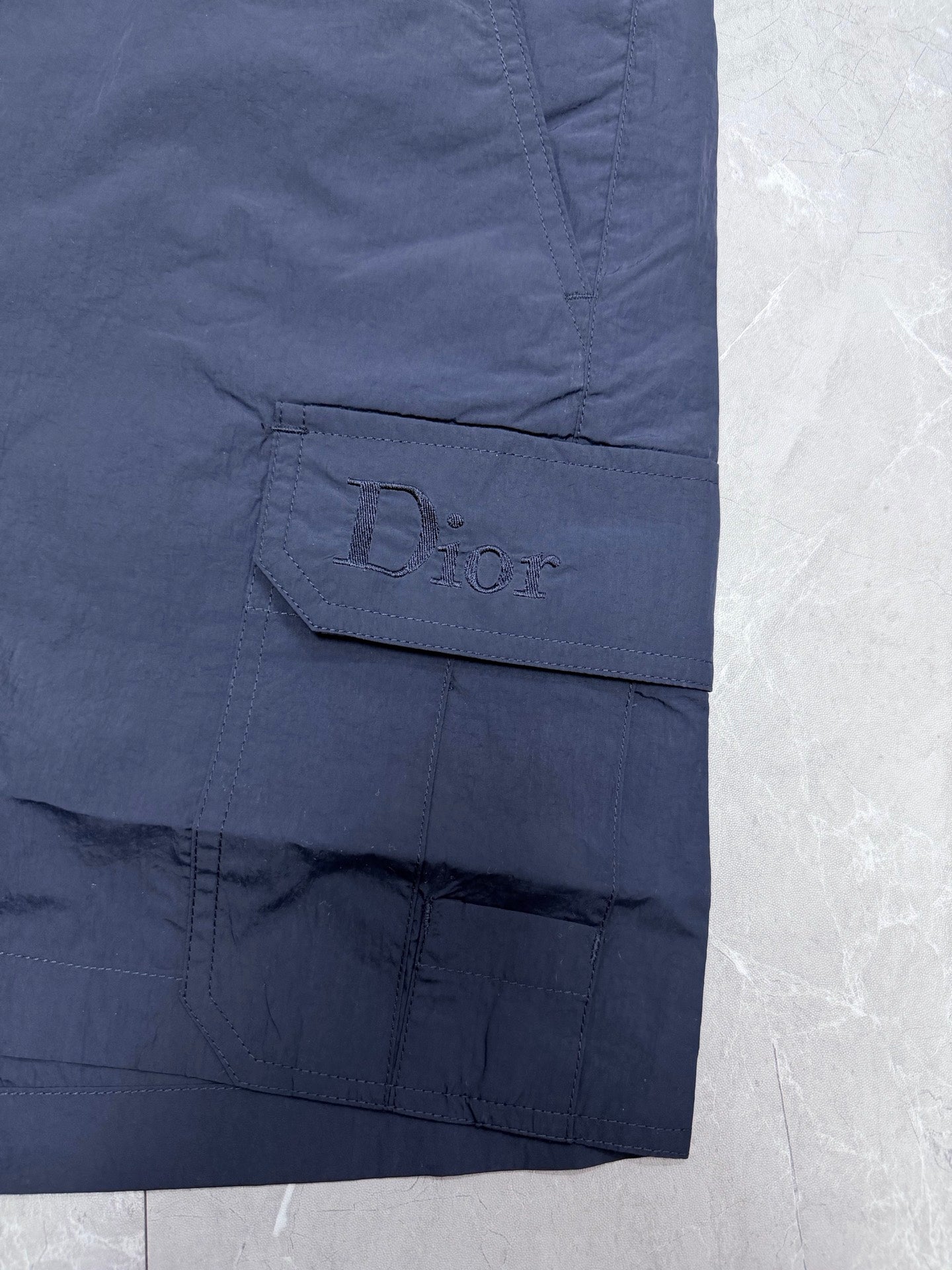 Navy Dior cargo pocket with embossed logo detail