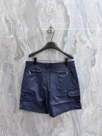 Navy Dior shorts on hanger, front with cargo pockets