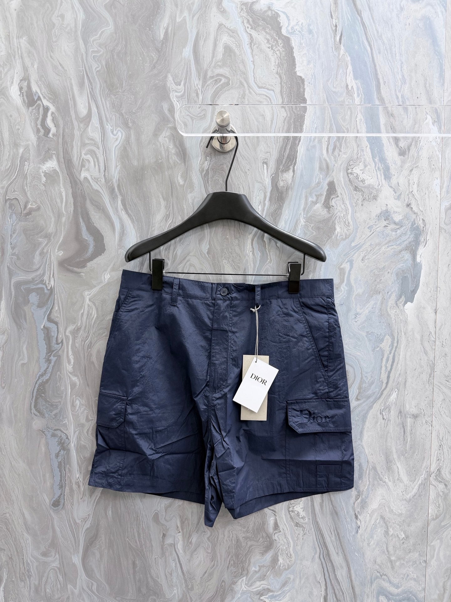 Navy Dior cargo shorts with drawstring waist and flap pockets