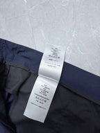Dior navy shorts waist with hanging care label and stitched waistband