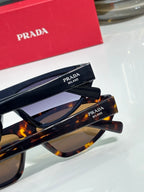 Prada sunglasses with tortoise and black frames, temple text detail