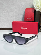 Prada sunglasses with black frames and dark gray lenses
