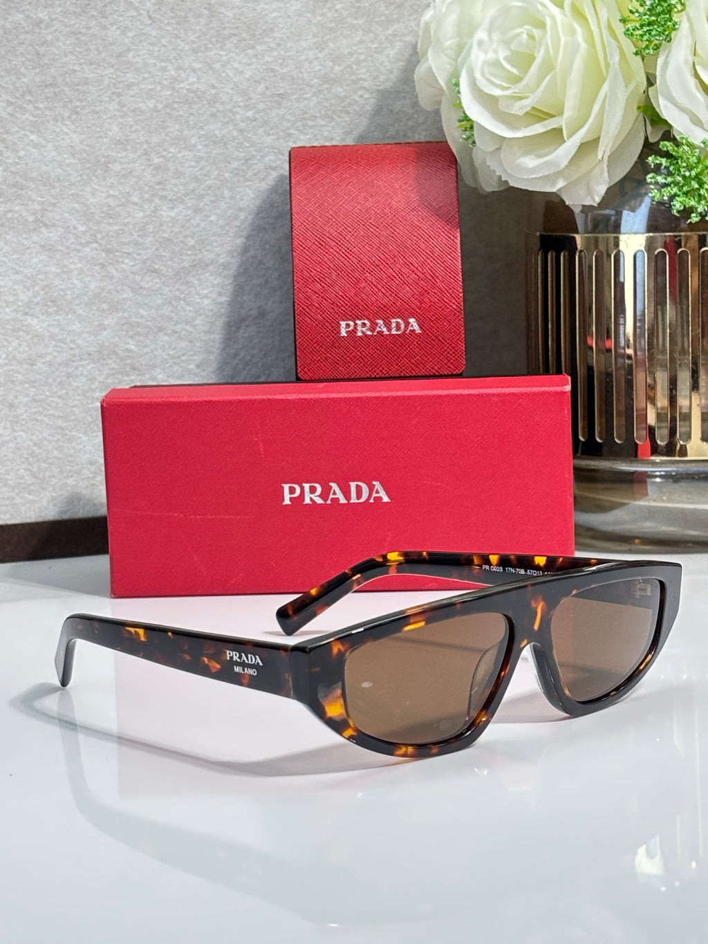 Prada sunglasses with tortoise frames and brown lenses