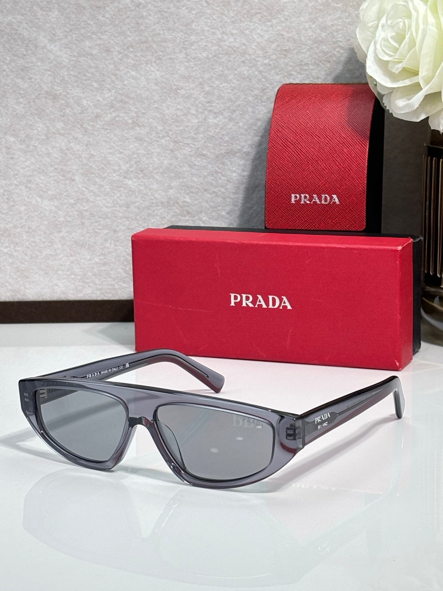 Prada sunglasses with dark gray frames and light gray lenses