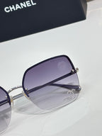 Purple-lens sunglasses with silver-tone frame and side hinge detail