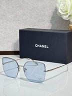Gold-tone sunglasses with light blue lenses and metal frame