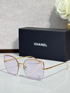 Gold-tone sunglasses with clear-to-lavender lenses and metal frame