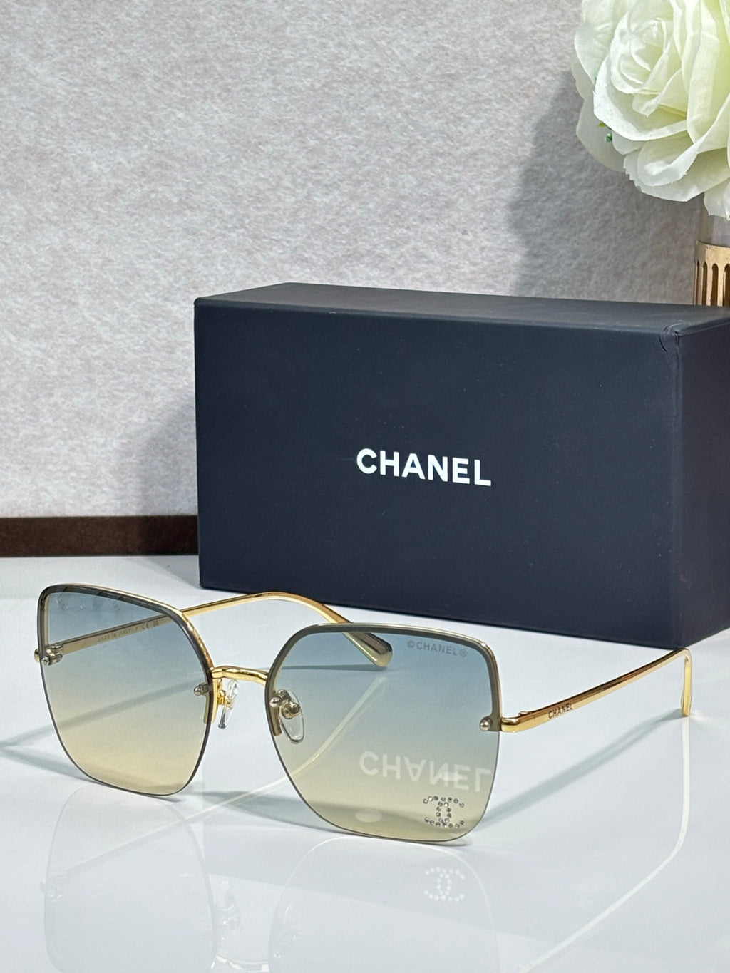 Gold-tone sunglasses with pale yellow lenses and metal frame