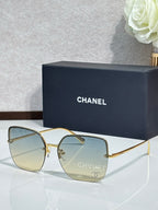 Gold-tone sunglasses with pale yellow lenses and metal frame