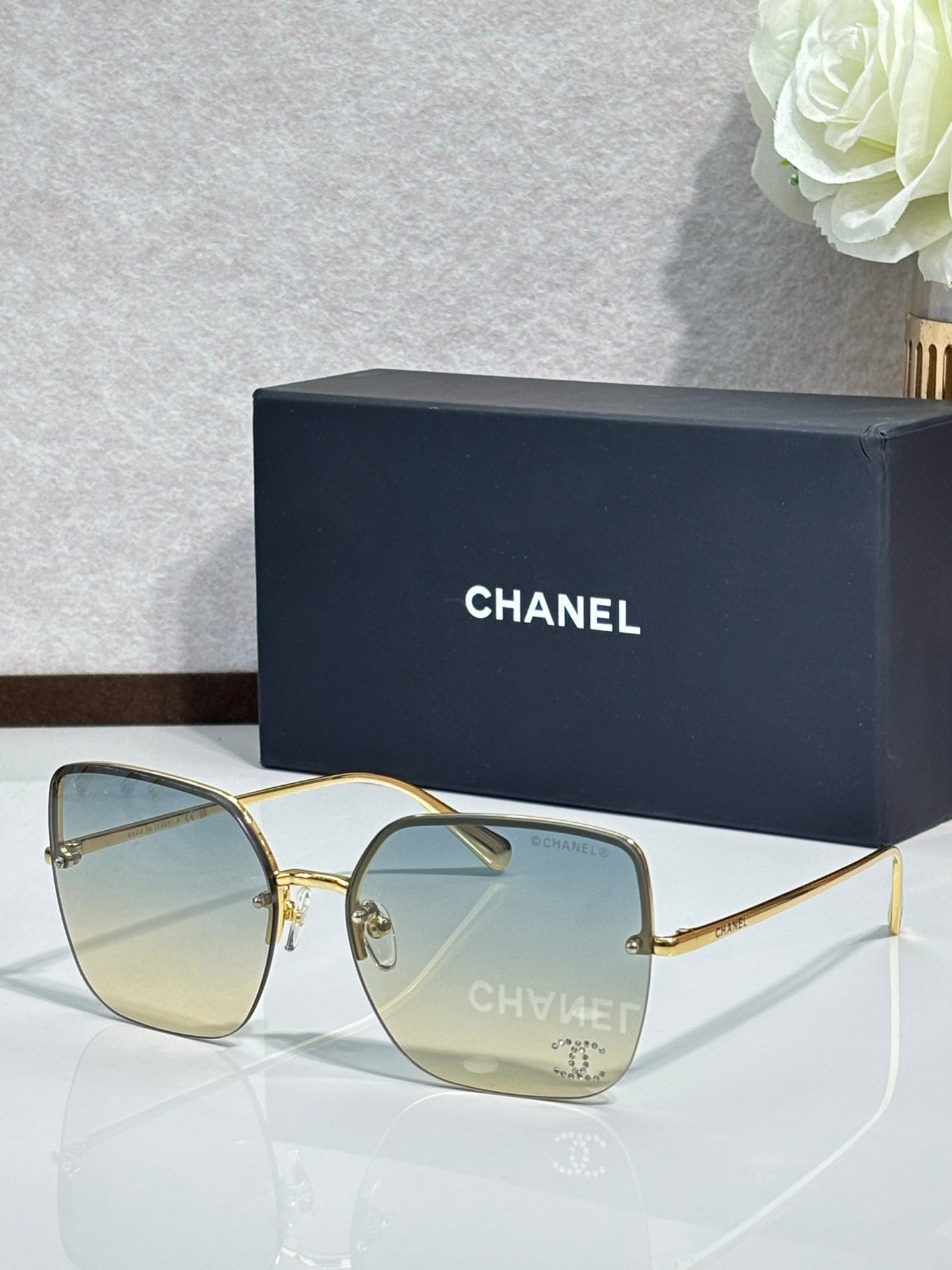 Gold-tone sunglasses with pale yellow lenses and metal frame