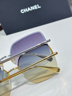 Gold-tone sunglasses with purple lenses and slim metal bridge
