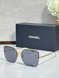 Gold-tone sunglasses with dark blue lenses and metal frame