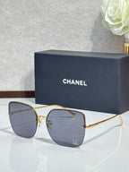 Gold-tone sunglasses with dark blue lenses and metal frame