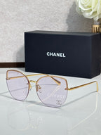Chanel sunglasses with gold-tone frame and light purple gradient lenses