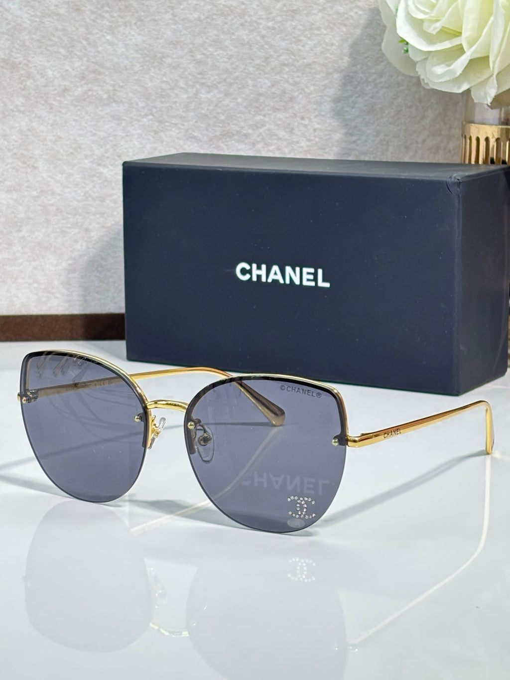 Chanel sunglasses with gold-tone frame and dark blue gradient lenses