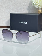 Chanel sunglasses with gold-tone frame and purple-tinted gradient lenses