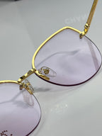 Chanel sunglasses close-up: gold frame with light purple lenses