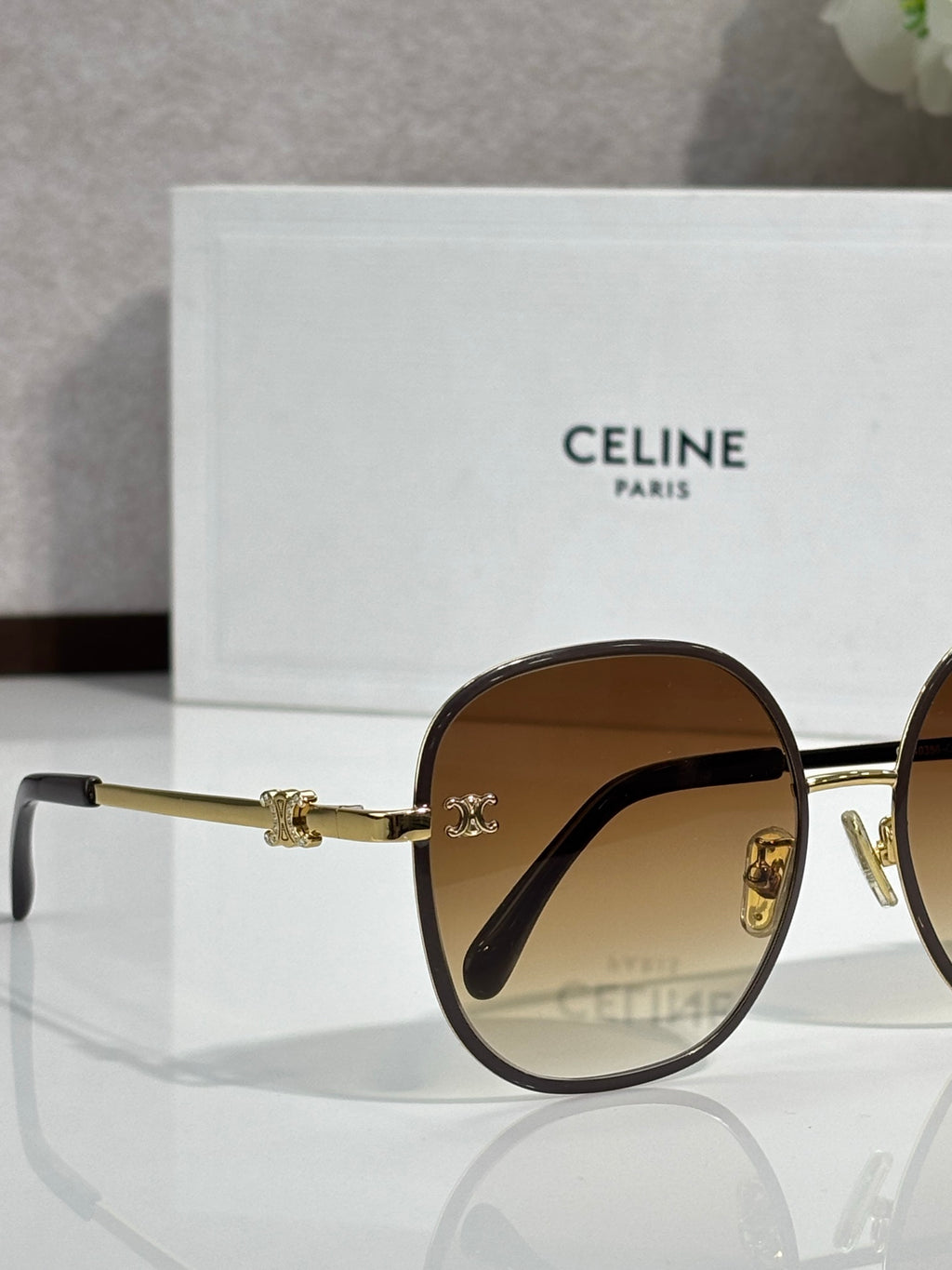 Celine round sunglasses close-up with dark lenses and gold-tone metal temples