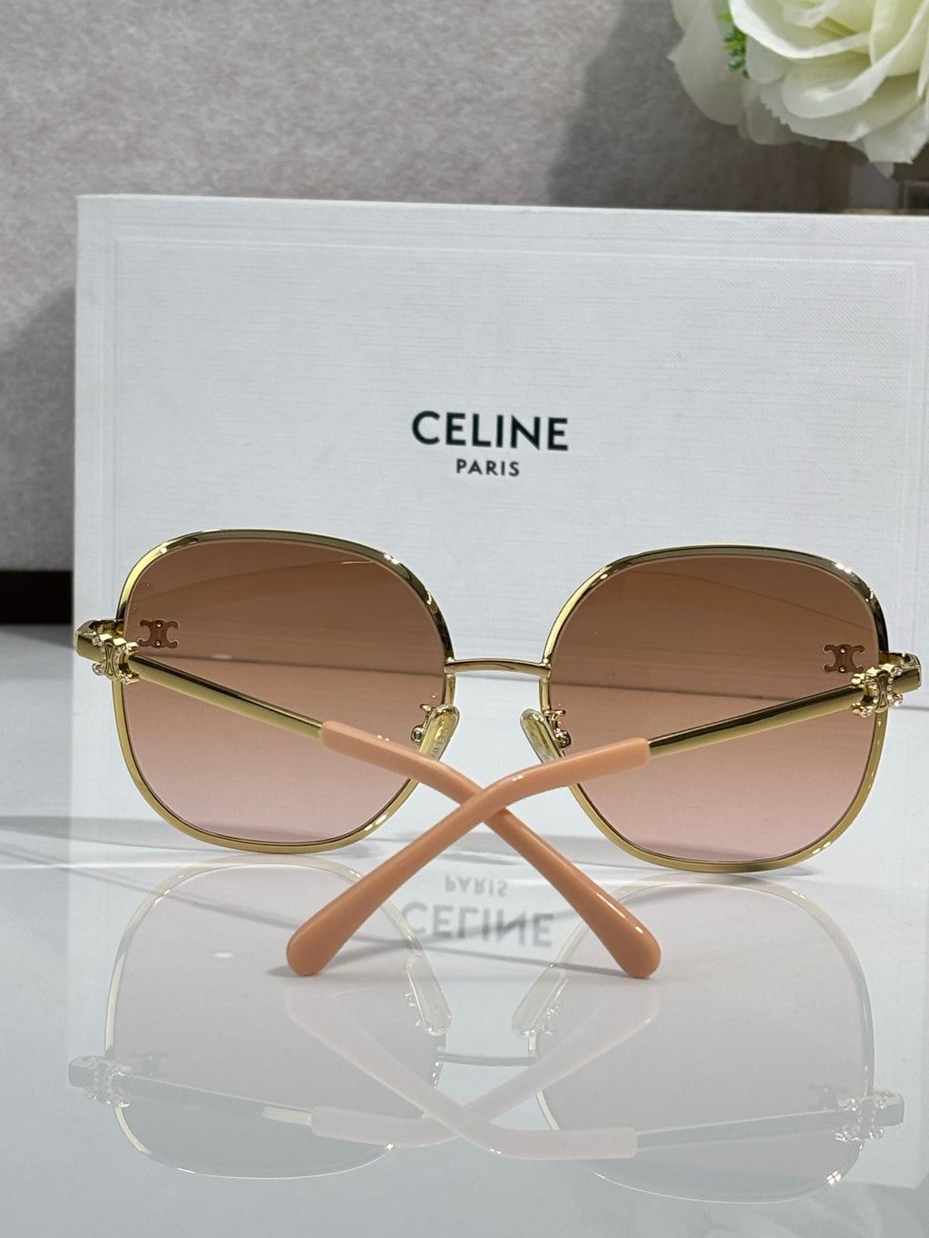Celine round sunglasses with light tan lenses, gold-tone frame, and pink arms