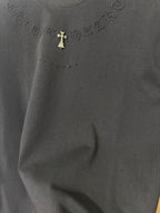 Black T-shirt chest embroidery with gold cross emblem and tiny speckled dots