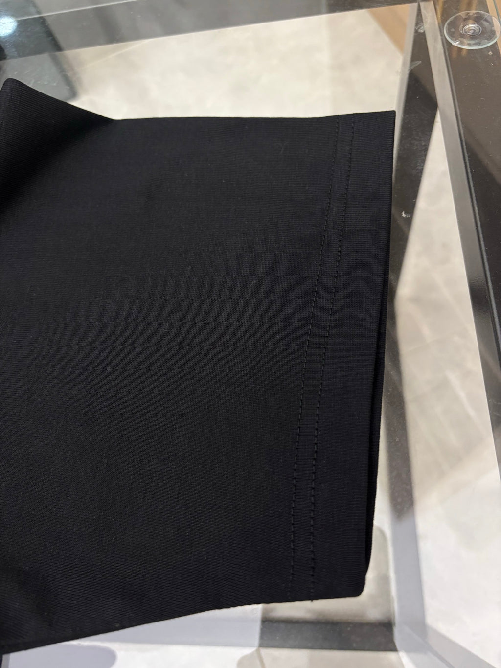 Black T-shirt hem with neat stitching detail