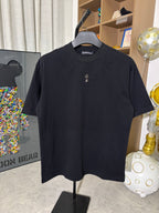 Black crew-neck short-sleeve T-shirt on hanger with gold cross chest emblem