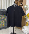 Black crew-neck short-sleeve T-shirt with small gold cross emblem on chest
