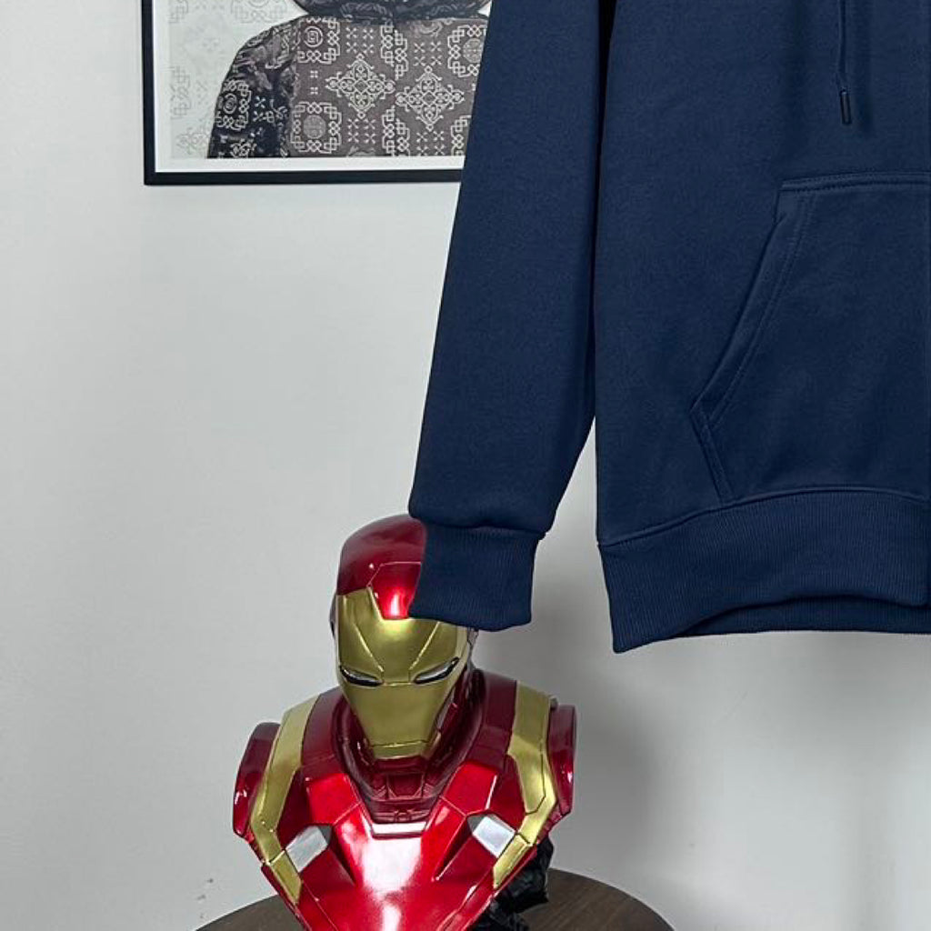 Dark navy hoodie sleeve and kangaroo pocket detail with ribbed cuff