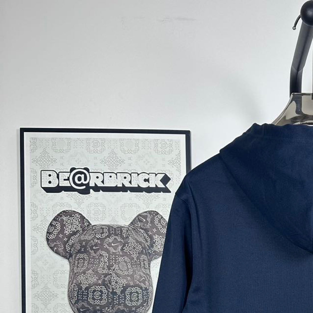 Dark navy hoodie back with hood, on hanger