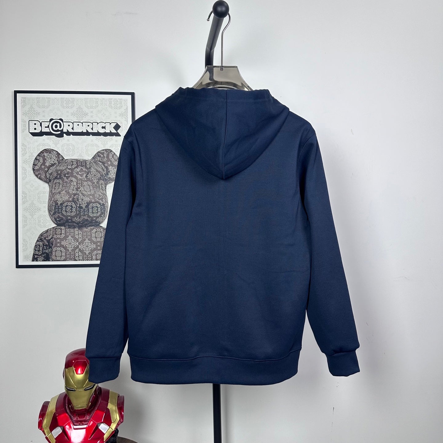 Dark navy zip hoodie, hooded back view on hanger